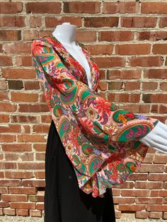 Gorgeous 70s inspired top with new style of repeating paisley psychedelic hippie pattern. Great summer time piece. Lovely brown and orange colors.  Front tie crop top with long bouncy butterfly sleeves. Material makes this a great summer time addition.with colors that are fun and eye-catching.  Easy to wear and you'll always look the great! Multiple ways to wear top, either tied in the front, wrapped around the waist and tied in the back or off shoulder. This top looks great paired with shorts, Festival Floral Print V-neck Top, Vintage V-neck Top With Boho Print, Spring V-neck Paisley Print Tops, Bohemian Multicolor V-neck Top, Colorful Hippie Tops For Spring, Flowy Printed Hippie Blouse, Flowy Multicolor Floral Print Tops, Hippie Pink V-neck Tops, Bohemian V-neck Top With Colorful Pattern