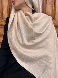 Presenting our "Ivory Elegance Pashmina Scarf" - an epitome of sophistication and refinement. This luxurious scarf features a delicate ivory hue that exudes timeless elegance. Crafted from premium-quality fabric, it offers unmatched softness and warmth, enveloping you in comfort throughout the day. With its intricate paisley design and subtle shimmer, this pashmina scarf adds a touch of glamour to any ensemble. Versatile and stylish, it can be draped in various ways to suit your personal style. Cream Pashmina Traditional Scarf, Cream Traditional Pashmina Scarf, Traditional Cream Pashmina Scarf, Elegant Cream Pashmina Shawl In Traditional Drape, Elegant Beige Pashmina Shawl With Traditional Drape, Luxury Formal Pashmina Shawl, White Silk Pashmina Shawl, Cream Pashmina Dupatta For Wedding, Luxury Pashmina Shawl For Formal Occasions