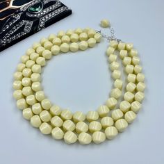 A statement piece exuding timeless elegance, this necklace features chunky beads in a creamy vanilla white hue. The beads' substantial size offers a bold presence, while their neutral tone ensures versatility and class. Perfect for those who appreciate understated luxury, this necklace complements a myriad of outfits, lending a sophisticated touch to both daywear and evening ensembles. - Necklace length is 16.5" shortest strand plus additional 3 inch extender chain for length adjustment. Matchin Light Weight Necklace, Short Layer, Long Layer, Friends Necklace, Autumn Necklace, Christmas Necklace, Gold Bead Necklace, Chunky Beads, Necklace White