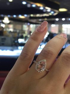 a woman's hand with a diamond ring on it