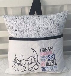 a pillow that is on top of a bed with the words dream high above it