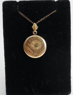 A cute old circle locket pendant with a lovely floral etching 1/20 12k gold filled chain and pendant. Older spring style clasp and delicate 20in chain. Cheap Antique Round Pendant Necklace, Vintage 14k Gold Locket Necklace, Gold Medallion Locket Necklace Stamped 14k, Vintage 14k Gold Locket Necklace Stamped 14k, Vintage Oval Necklace With Coin Pendant, Dainty 14k Gold Locket Necklace, Vintage Oval Jewelry With Coin Pendant, Antique Medallion Necklace With Locket, Heirloom Style Locket Necklace With Vintage Charm