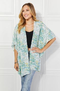 A stunning fashion piece that effortlessly combines elegance, comfort, and a touch of playfulness. This kimono is designed to make a statement and elevate your wardrobe to new heights of style. The colors burst with life, creating a mesmerizing visual effect that is sure to turn heads wherever you go. The soft, flowing fabric drapes gracefully over your body, exuding an air of sophistication and grace. What sets this kimono apart is the exquisite ruffle side detail. The delicate ruffles cascade down the sides, adding a touch of whimsy and femininity to the design. Pattern type: Floral Style: Casual, Chic Features: Ruffle Neckline: Open front Length: Long Sleeve length: Short sleeves Sleeve type: Dolman sleeves Sheer: Yes Material composition: 100% polyester Stretch: No stretch Care instruc Oversized V-neck Spring Cover-up, Spring Flowy Wrap Cover-up, Casual Spring Cover-up With Kimono Sleeves, Summer Tops With Kimono Sleeves For Daywear, Oversized V-neck Cover-up For Spring, Flowy V-neck Kimono For Day Out, Spring Floral Print Outerwear For Loungewear, Flowy Spring Loungewear Cover-up, Floral Print Open Front Outerwear For Beach