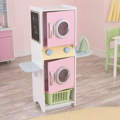 a play kitchen with pink and green appliances