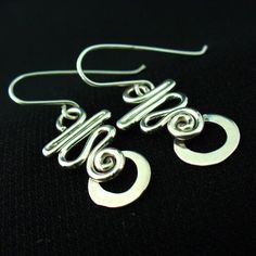 These earrings are hand crafted in solid sterling silver.I use 16 gauge wire for these so they're nice and light but not flimsy.For a unique,long lasting and clearly handmade pair of everyday dangles that won't break the bank.These will do the trick. Spiral Shaped Sterling Silver Jewelry, Minimalist Spiral Jewelry With Matching Earrings, Spiral Sterling Silver Earrings As Gift, Handmade Silver Drop Wrap Earrings, Spiral Sterling Silver Earrings For Gift, Silver Wire Wrapped Drop Earrings, Unique Silver Plated Wire Earrings With Ear Wire, Unique Silver Plated Wire Earrings, Minimalist Spiral Nickel-free Jewelry