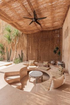 an outdoor living area with couches and tables