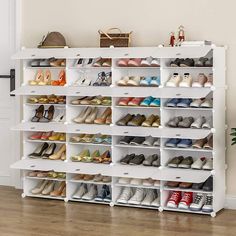 a white shoe rack filled with lots of pairs of women's shoes on top of a hard wood floor