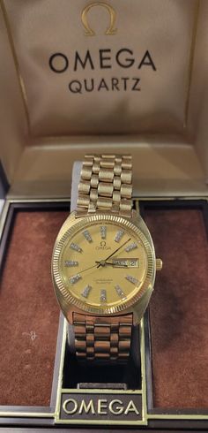 Hi Buyers!!! You are buying a Rare Vintage Omega Constellation Day/Date 10K Gold filled with diamonds hour markers and a 1345 swiss Movement Quartz Men's Watch. Pre-owned one owner in good conditions for its age with the Box, please  see all the pictures and zoom in as they are part of my description and all measurements are shown. It was just serviced and new fresh battery 8-10-24, all functions working great amd keepingtime. You will definitely not find one like this, maybe a similar one but none with this killer Real Diamond Dial. Features a handsome gold dial with real diamonds as hour markers, luminous hands, day/date indicator, all original band and crown. The push button under the crown controls the date #, to set the day turn crown 24hrs and  the button on the center of the crown c Omega Watch Vintage, Omega Constellation, Vintage Omega, Wristwatch Men, Men's Watch, Real Diamonds, 10k Gold, Vintage Watches, Omega Watch