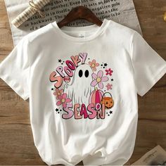 Women’s Casual Short Sleeve Halloween Shirt. Cute Retro 70s Look “Spooky Season” Gift: Cute Acrylic Ghost With Pumpkin Dangle Earrings 70s Halloween, Ghost Shirts, Ghost With Pumpkin, Casual Halloween, 70s Look, Halloween Graphic Tees, Girls Halloween, Ghost Shirt, Halloween Shirts