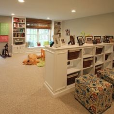 a living room filled with lots of furniture and bookshelves