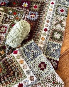 two crocheted granny afghans and a ball of yarn on a wooden floor