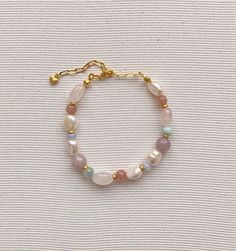 Pearl bracelet Freshwater pearl jewelry Rainbow, soft bracelet features Baroque pearls Multi-colored natural stone (pink quartz, chalcedony,larimar, kunzite and jade) Gold plated brass clasp Length - 16-22 cm(Adjustable) Pearl and stone vary in size and shape Please contact us for specific questions, size, color, etc. -Care -Delicate Jewelry, Especially Dainty Chain Designs, Should be Treated with Care While Wearing to Prevent Breakage. -Many factors can influence the condition of the jewelry. T Elegant Pastel Jewelry Gift, Natural Stones Pearl Bracelet As A Gift, Pastel Gemstone Beads Jewelry For Gifts, Natural Stone Pearl Bracelet As Gift, Pearl Bracelet With Natural Round Beads, Natural Stone Pearl Bracelet Gift, Natural Stone Pearl Bracelet With Round Beads, Pink Opal Bracelets As Gifts, Handmade Pastel Bracelets For Gift