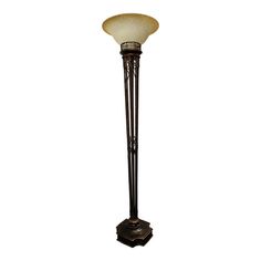 a floor lamp with a glass shade on top