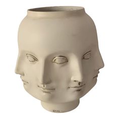 a white ceramic face vase with eyes closed