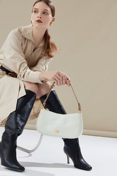 The Carrie Shoulder Bag has a vintage-inspired look with a gentle curve and slim structured silhouette. The signature belt loop detail allows for the strap to be lengthened for a hands-free style or carried on hand. Optional Add-ons: Charmed Chain. Classic Clutch Baguette Bag With Detachable Handle, Luxury Baguette Shoulder Bag With Single Strap, Luxury Baguette Bag With Single Shoulder Strap, Elegant Everyday Baguette Bag With Detachable Strap, Elegant Leather Baguette Bag With Adjustable Handle, Elegant Everyday Handheld Baguette Bag, Elegant Baguette Bag With Adjustable Handle For Everyday Use, Chic Handheld Baguette Bag For Formal Occasions, Elegant Baguette Bag For Everyday Use