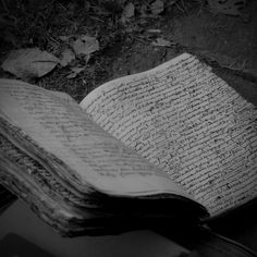 an old book is laying on the ground