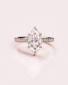 an engagement ring with a pear shaped diamond in the center