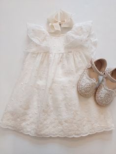 Elevate your baby girl's summer wardrobe with this stunning off-white Mayoral dress. The knee-length dress is made with embroidered lace fabric and features flutter sleeves, making it perfect for your little one's playtime or a dressy occasion.  This NWT dress is suitable for babies aged 9 months, making it a perfect addition to their wardrobe for the warmer months. The dress is ideal for a variety of events, and the embroidered lace fabric adds a touch of elegance that will make your baby girl stand out. cotton blend dress, 100% cotton lining. Summer Cotton Dresses With Scalloped Lace, Summer Cotton Dress With Scalloped Lace, Short Sleeve Embroidered Dress For Baptism, White Cotton Dress With Scalloped Lace, Cream Ruffled Lace Dress For Baptism, Cream Lace Ruffle Dress For Baptism, White Floral Embroidered Dress For Baptism, Summer Beige Broderie Anglaise Dress, Off-white Lace Dress For Baptism