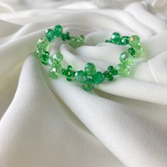 Add a touch of elegance to any outfit with this exquisite green, glass beaded bracelet. Each bead is carefully selected for it's vibrant color and sparkle, creating a stunning piece of jewelry. The bracelet is handmade, featuring a durable silver, stainless steel lobster clasp, ensuring a perfect fit for any wrist size. Whether for a special occasion, or everyday wear, this handmade bracelet is a perfect accessory or, thoughtful gift. Details: Materials: High quality green glass beads, stainless Green Crystal Bracelets For Party, Elegant Czech Glass Beaded Bracelets For Party, Green Crystal Bracelet For Party, Faceted Green Beaded Bracelets As Gift, Green Polished Beads Stretch Bracelet As Gift, Elegant Green Stretch Bracelet For Party, Czech Glass Beaded Bracelets With Round Beads For Party, Czech Glass Beaded Bracelets For Party, Gift Green Faceted Beaded Bracelets