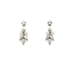 These embellished leaf stud earrings radiate elegance and sophistication. The shimmering details are a perfect addition to any classy bridal look. Also available with pearl detailing. -AAA Cubic Zirconia -Approximately 0.3in from widest point x 0.8in long (0.8cm x 2cm) -Rhodium plated, non-tarnish finish for brilliance Dainty Cubic Zirconia Drop Bridal Earrings, Formal Bridal Diamond Clip-on Earrings, Dainty White Cubic Zirconia Bridal Earrings, Delicate Dangle Cubic Zirconia Pearl Earrings, Pearl-embellished Cubic Zirconia Drop Earrings, Cz Earrings, Wedding Earrings, Bridal Looks, Rhodium Plated