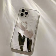 an iphone case with flowers on it sitting on a white sheeted surface and the words, do not touch me now