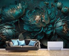 a couch sitting in front of a wall with flowers on it