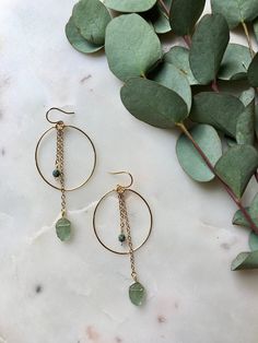 HOLIDAY ORDER DEADLINE: Orders placed after December 18 will not be shipped until January 3!  Clear aqua, green, or turquoise leaf chain dangles on a gold wire hoop. Including the ear wire, they are 3in long by 1 1/8in wide. Made with gold plated wire; wire wrapped detail to secure the hoop is attached to an elegant ear wire. If you have allergies that restrict which metals you can wear, please send me a message first before purchasing. Visit poppyjewelrydesigns.com for more inventory and new st Green Teardrop Brass Jewelry, Green Teardrop Jewelry With Ear Wire, Green Teardrop Jewelry With Adjustable Chain, Green Brass Drop Earrings, Green Minimalist Metal Jewelry, Minimalist Green Metal Jewelry, Green Dangle Metal Hoop Earrings, Green Dangle Hoop Earrings In Metal, Green Wire Wrapped Long Drop Earrings