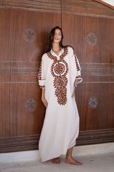 *Note : The kaftan in the video is a different color and is only displayed to show the fit, flow, and cut of the Kaftan. You will receive the one in the pictures.* A bohemian flash caftan made of light mesh of linen and poly, the fabric is unique in that it's very flowy and not the usual feel and touch of linen. This Kaftan is ideal to wear for any casual occasion. Whether taking a trip down the shopping lane, or home-based kitty parties, or about anything else, wearing this dress will make you Traditional Maxi Dress With Multicolor Embroidery, Embroidered Multicolor Kaftan For Eid, Beige Bohemian Kaftan For Eid, Traditional Long Sleeve Abaya For Vacation, Traditional Multicolor Kaftan With Resham Embroidery, Bohemian Cream Kurta For Festivals, Traditional Free Size Kaftan For Festivals, Long Multicolor Kaftan With Resham Embroidery, Multicolor Embroidered Long Maxi Dress