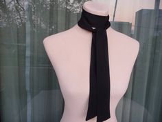 This skinny black scarf is made by 100% silk satin, and creates a beautiful and lovely picture for you to wear with your favorite outfit.  It has the perfect length to wear in different ways like as a bow, a skinny scarf or tie around your neck or on your head. It can be use as a headband and choker necklace also. So many ways to wear it!   Size: 3,5cm x 1,38 cm (28 euro) 5 cm x 138 cm (35 euro) 3,5 cm x 1,80 cm (35 euro) 5 cm x 1,80 cm (42 euro) 7 cm x 1,80 cm (49 euro) Wash gently in cold water. It's a wonderful gift choice for everyone. Check also my other silk scarves: https://www.etsy.com/shop/ArtTetisCollections Ready to ship. Thank you for visiting my shop. Elegant Adjustable Neckwear For Gifts, Elegant Adjustable Neckwear As Gift, Elegant Adjustable Neckwear As A Gift, Black Silk Scarf For Party, Formal Scarf Neckwear, Classic Satin Scarves As Gift, Elegant Black Neckwear For Gift, Elegant Satin Scarf For Gift, Silk Party Ties