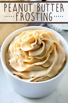 a white bowl filled with peanut butter frosting