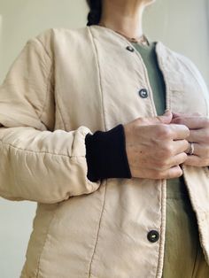 Soft cotton quilted liner jacket in faded peach with brown cuffs. Front buttons. Fabric: Cotton Fit: S Measurements (flat): Armpit to armpit 21 Sleeve 24 Shoulder (across) 17.5 Length (front) 18.25 Length (back) 23 Condition: Excellent Quilted Liner Jacket, Liner Jacket, Cotton Quilts, Fabric Cotton, Chef's Jackets, Cuff, Fabric