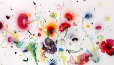 an abstract painting with many different colors and shapes on it's surface, including flowers