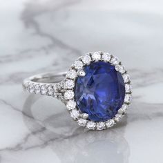 Reminiscent of Princess Diana's and Kate Middleton's engagement ring Perfect way to pop the question! Something blue and something new for your wedding day! GIA Certified! Who wouldn't love a diamond halo ring with a blue sapphire center stone. Ever since Princess Di's famous engagement ring, women all over the world have discovered the beauty of blue sapphires. We love this ring especially for the intricate design of the gallery. This very special ring should be for that very special someone on Fine Jewelry Halo Ring With Brilliant Cut Lab-created Sapphire, Blue Lab-created Sapphire Halo Ring For Anniversary, Elegant Halo Ring With Lab-created Sapphire Gemstone, Luxury Classic Halo Ring With Lab-created Sapphire, Kate Middleton Engagement Ring, Luxury Blue Halo Ring With Lab-created Sapphire, Famous Engagement Rings, Special Ring, Natural Blue Sapphire