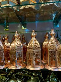 brass lanterns are lined up in a row