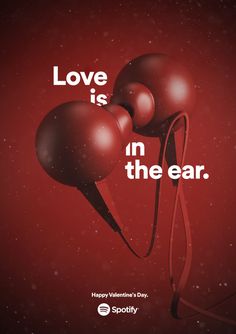 a red poster with three balls and the words love is in the ear