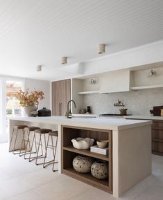 a kitchen with an island and several stools