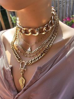 This handmade 24 K gold  plated chain layered multi stand stacked punk goth edgy style necklace set is a stunning piece of jewelry that is perfect for those who love bold and edgy accessories. This is two necklaces, the big chunky choker that is adjustable with a built-in extender from 14" to 17", and the 4-strand drop festoon design necklace (also adjustable 15" to 18"). Adding depth and dimension to the piece is a u lock and spearhead pendant. Very punk, grunge aesthetic! This necklace set is Multi Chain Choker Necklace With Cross, Luxury Double Chain Multi-strand Necklace, Good Necklace Stack, Trendy Multi-strand Chunky Chain Jewelry, Punk Style Gold Jewelry With Adjustable Chain, Gold Punk Jewelry With Adjustable Chain, Punk Gold Chain Jewelry, Gold Punk Clavicle Chain Necklace, Punk Gold Choker Jewelry