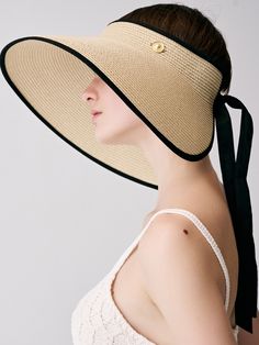 Editor's Notessieor presents unique and stylish hats that add a cute accent to your look. - Made of raffia fabric- Wide and long visor- Strap closure on the back- Vintage button embellished- Classic and trendy mood Measurements (in.)One Size- Visor: 5.12 in.- Depth: 1.97 in.- Circumference: 21.65 ~ 24.41 in. Composition & Care- Material: 100% Raffia- Avoid direct heat and moisture- Natural dry in the shade if wet- Do not bleach- Do not iron- Do not dry clean- Please refer to t Elegant Straw Visor Hat, Elegant Boater Hat With Visor For Spring, Elegant Beige Visor Sun Hat, Elegant Spring Boater Hat With Visor, Chic Visor Sun Hat For Kentucky Derby, Elegant Visor Straw Hat For Vacation, Elegant Visor Boater Hat For Vacation, Chic Adjustable Hats For Kentucky Derby, Elegant Boater Hat With Visor For Vacation