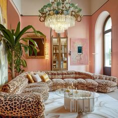 a living room filled with furniture and a chandelier