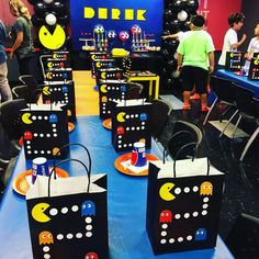 a room filled with lots of black and white bags covered in pacman paper bags