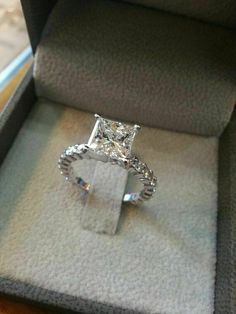 a princess cut diamond ring in a box