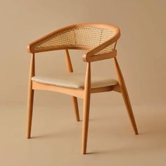 a wooden chair with an upholstered seat and armrest, on a beige background