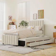 a white bed sitting on top of a wooden floor