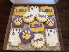 a box filled with decorated cookies in the shape of shirts and ties