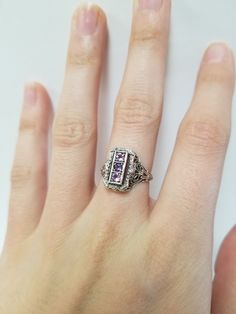 Once in a Blue Moon beautiful vintage finds. Amethyst Filigree Ring // Solid 925 Sterling Silver. Antique Remake. There are three 0.08 ct stones in a beautiful filigree setting. Beautiful anniversary present, Mother's Ring, or Birthday gift. Size: 6, 7, 8 US* Total Carat Wt: 0.24 ct Band width: 1.6 mm *Ring sizes may be 1/4 smaller than size selected Free Shipping & packaged in a black velvet ring box ready to gift! Vintage Emerald-cut Amethyst Ring For Anniversary, Fine Jewelry With Accent Stones For Collectors, Vintage Emerald Cut Amethyst Ring For Anniversary, Vintage Emerald Cut Amethyst Ring Gift, Vintage Purple Sapphire Gemstone Ring, Heirloom Purple Rings With Accent Stones, Vintage Silver Amethyst Ring With Accent Stones, Vintage Amethyst Ring With Accent Stones For Collectors, Vintage Silver Amethyst Ring Birthstone