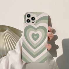 a woman is holding up her phone case with a heart on the front and side