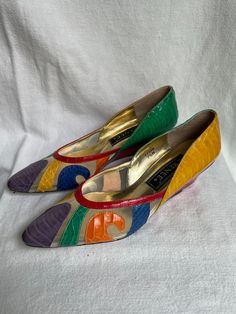 We are so in love with these shoes!  They scream 1980s early 1990s fashion.  Multi Color Snakeskin Leather with a closed toe and sheer sectioned design.  Overall condition is very good, with the exception of a repair needed on the left foot heel.  The black heel has come off and needs to be replaced.   This will be a minor repair at a shoe shop.  These heels were acquired from a large estate in South Charlotte.  While I would rate these very good vintage condition, the buyer is the final judge. Vintage Pointed Toe Heels In Synthetic Material, Vintage Synthetic Pointed Toe Heels, Retro Wedge Heels For Party, Vintage Slip-on Heels For Spring, Vintage Synthetic Heels With Round Toe, Vintage Synthetic Round Toe Heels, Vintage Synthetic Closed Toe Heels, Vintage Synthetic Heels For Party, Vintage Party Heels In Synthetic Material