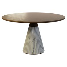 an oval wooden table sitting on top of a white base with black and brown stripes