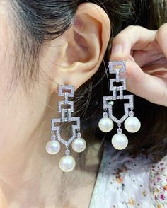 We are presenting you a HUGE pair of ONE OF A KIND, CHANDELIER, Genuine, CLASSIC WHITE South Sea Pearls, extremely FINE AA+, LUSTROUS and Rare! Accenting the 6 pearls are 144 pieces of E/VS Natural diamonds, weighting a total of 1.64 carats. Set in fabulously designed 18K solid white gold earrings! TIMELESSLY CLASSIC! WITH GORGEOUS Art Deco DESIGN. ONLY ONE ITEM AVAILABLE!! NO DUPLICATES!! WHAT YOU SEE IN THE PICTURES IS WHAT YOU WILL GET SOLIDLY HANDCRAFTED EARRINGS! SUGGESTED RETAIL VALUE: $10 Luxury Pearl Dangle Earrings For Formal Occasions, Diamond White Aaa Quality Jewelry For Wedding, White Gold Chandelier Earrings With Elegant Design, Exquisite High Luster Pearl Earrings For Wedding, Elegant Diamond Chandelier Earrings, Diamond Pearl Dangle Earrings With Elegant Design, Elegant Diamond White Dangle Bridal Earrings, White Diamond Drop Bridal Earrings, Luxury Aaa Quality Earrings For Wedding