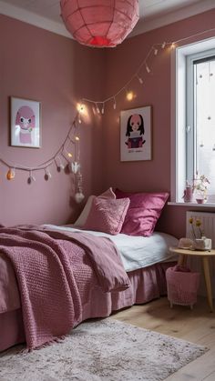 a bedroom with pink walls and lights on the ceiling